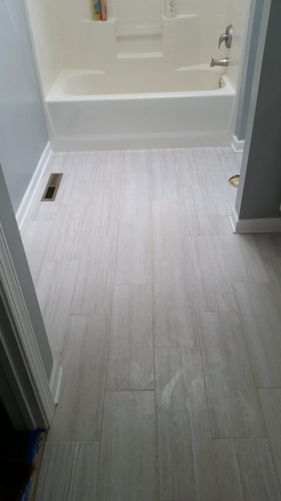 Bathroom finished with light plank tile flooring