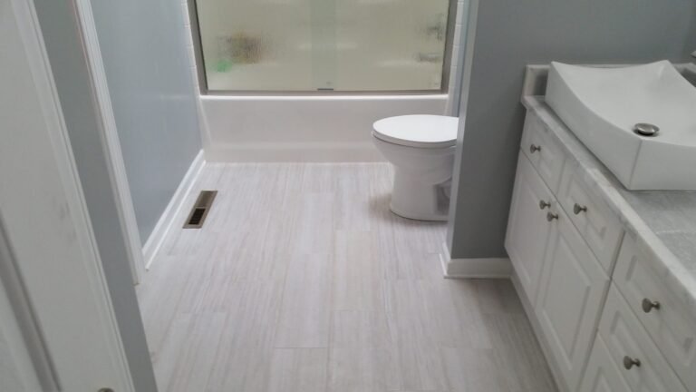 Updated bathroom with a white vanity and new floor