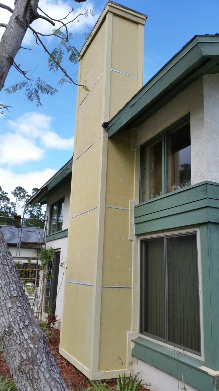 Exterior chase rebuilt with new siding panels after wood rot repair