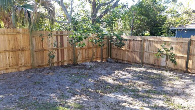 Backyard enclosed by the new wood fence
