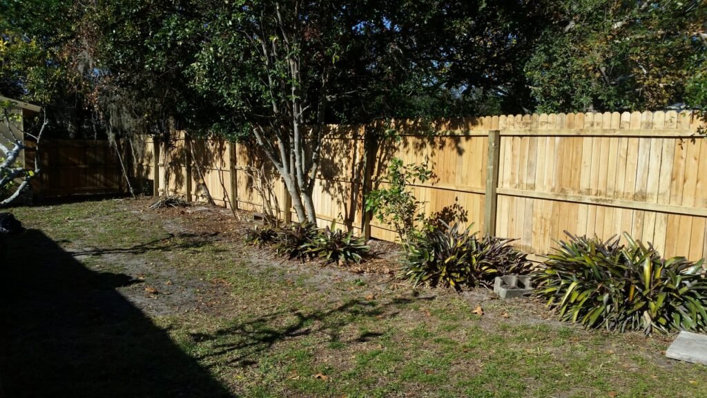 New wood privacy fence along a backyard