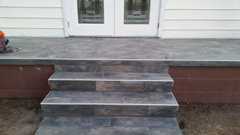 Front porch and steps finished in dark wood-look tile