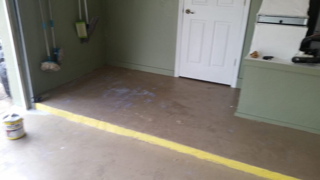 Garage floor before coating, stained and unfinished