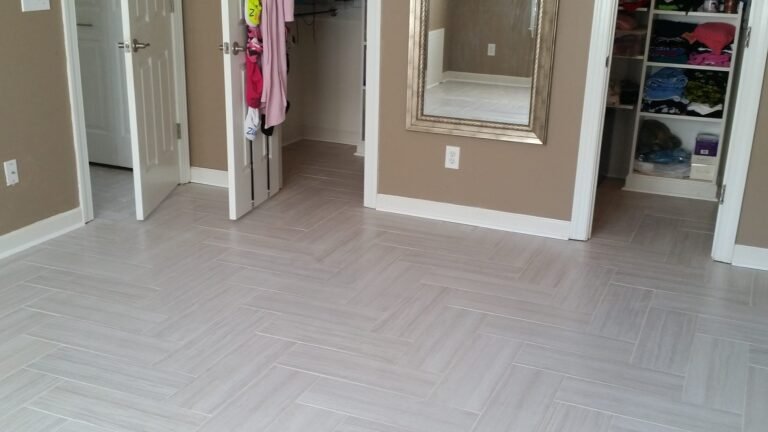 Bedroom finished in light herringbone plank tile