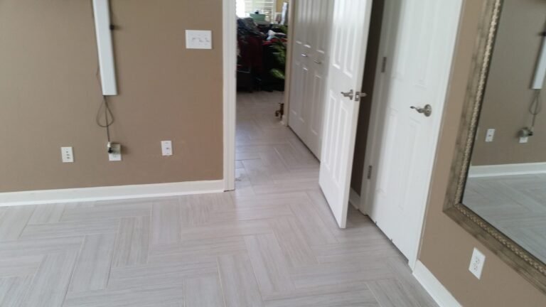 Herringbone tile floor running into a closet doorway