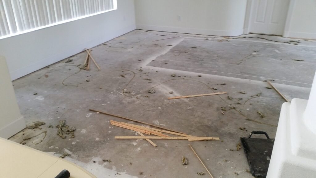 Living room slab with old carpet tack strips before new flooring