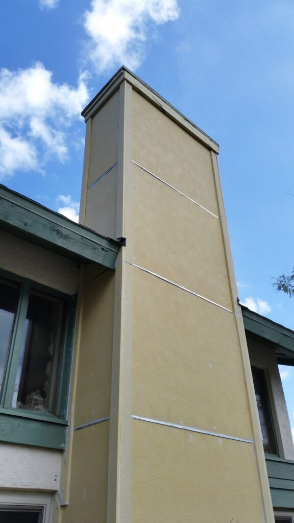 Exterior chase finished with new siding after repair