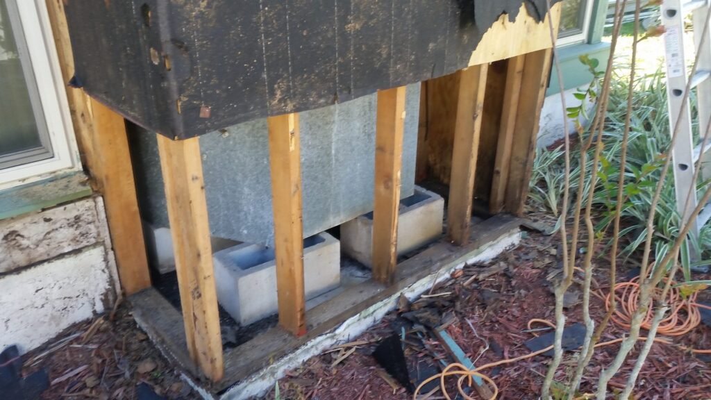 Rotted wood at the base of an exterior chase
